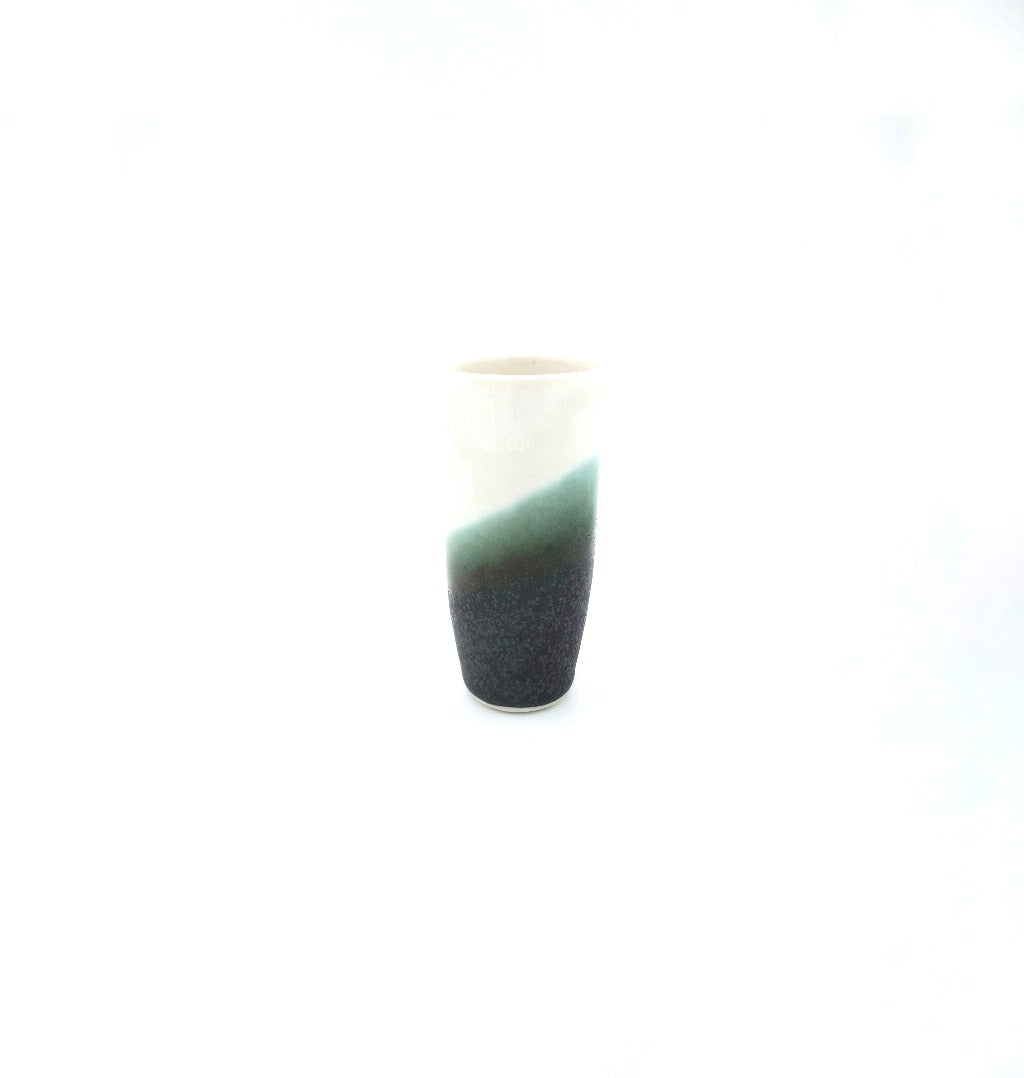 Kaolin - Iceramic. The &quot;Pole&quot;, a shotglas made of porcelain. It comes in many colors, where the glaze is inspired by the Icelandic nature, the lavaand moss fields, the black beaches and the melting icebergs.