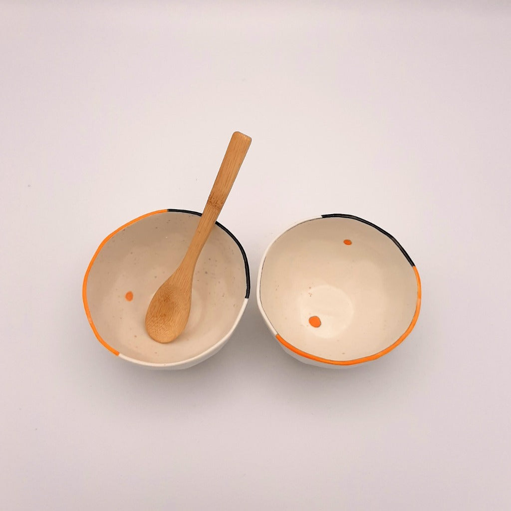 Kaolin - Guðný Magnúsdóttir - ICE CREME is a set of two small porcelain bowls, each with its own small differences and hand painted with black and red lines on the edge.