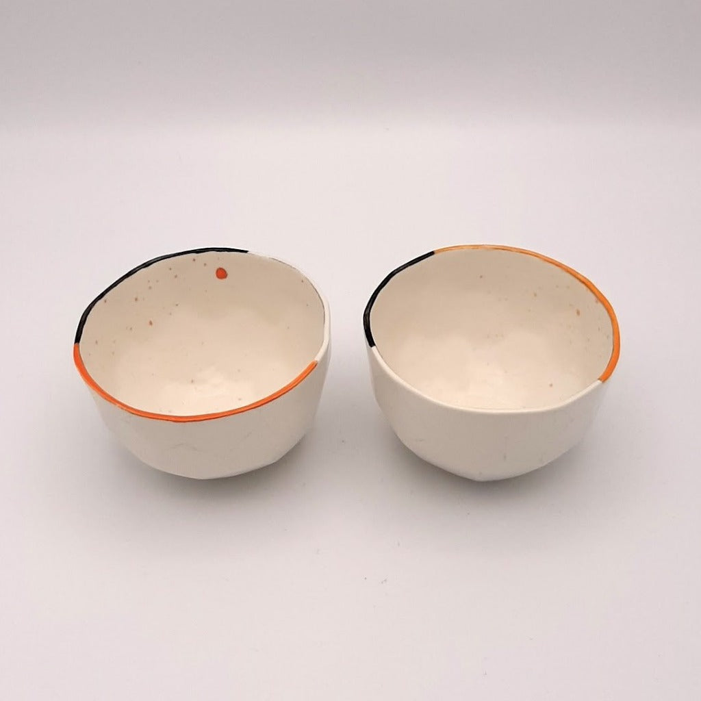 Kaolin - Guðný Magnúsdóttir - ICE CREME is a set of two small porcelain bowls, each with its own small differences and hand painted with black and red lines on the edge.  