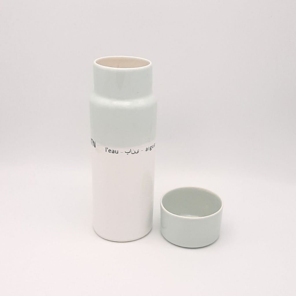 Kaolin - Guðný Magnúsdóttir - H2o WATER KARAFE - are designed in remembrance of the importance of water for all living creatures, the text says water in different languages. ICE- a water bottle in two white glazes.  The water bottle comes with a cap.
