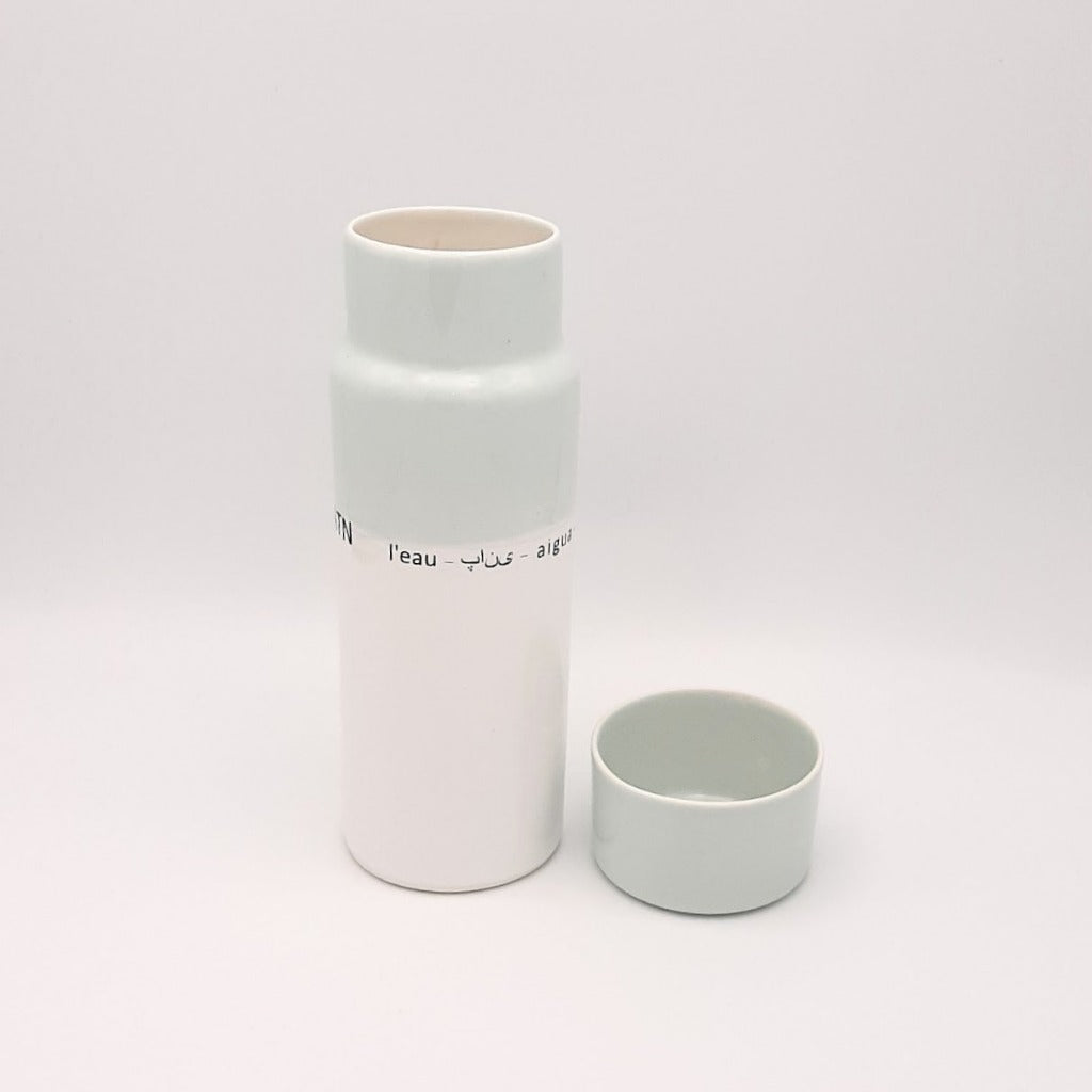 Kaolin - Guðný Magnúsdóttir - H2o WATER KARAFE - are designed in remembrance of the importance of water for all living creatures, the text says water in different languages. ICE- a water bottle in two white glazes.  The water bottle comes with a cap.