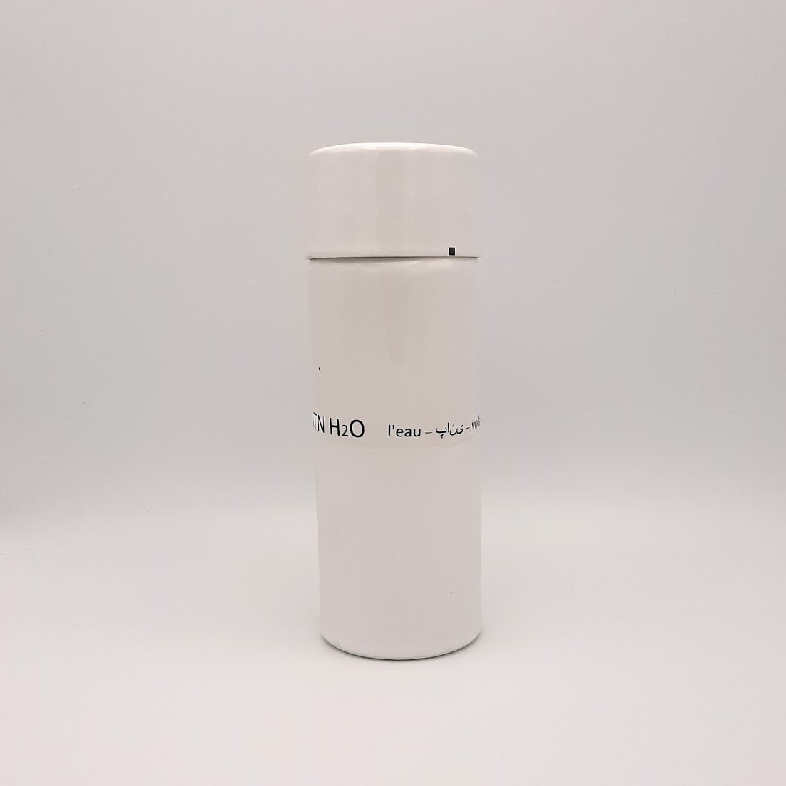 Kaolin - Guðný Magnúsdóttir - H2o WATER KARAFE - are designed in remembrance of the importance of water for all living creatures, the text says water in different languages. ICE - a water bottle in two white glazes. The water bottle comes with a cap.