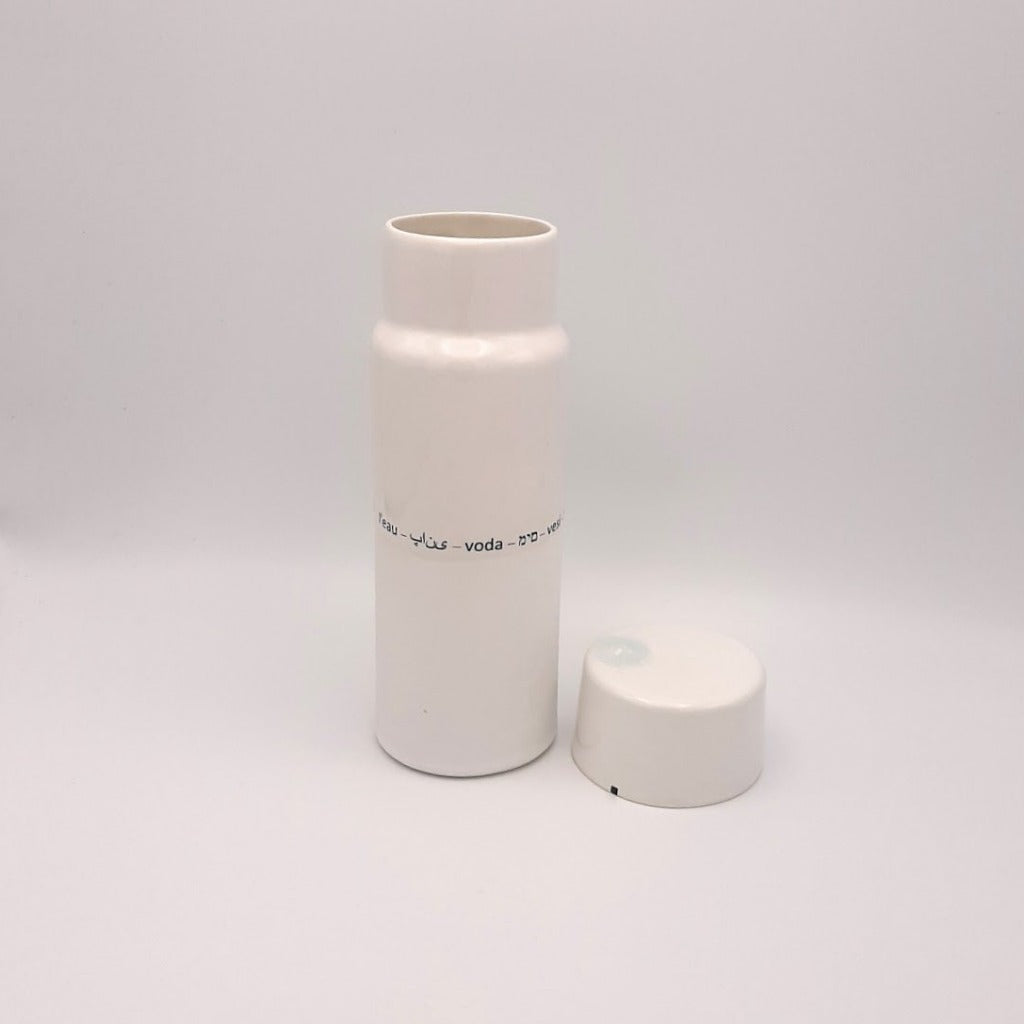 Kaolin - Guðný Magnúsdóttir - H2o WATER KARAFE - are designed in remembrance of the importance of water for all living creatures, the text says water in different languages. ICE- a water bottle in two white glazes.  The water bottle comes with a cap.